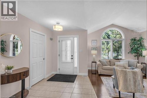 Entryway featuring tile flooring and a decorative front door with transom sidelights - 65 Thistlemoor Drive, Caledonia, ON - Indoor