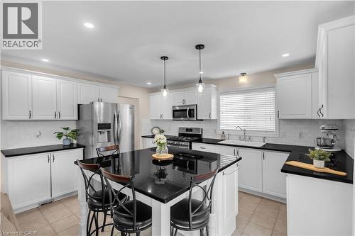 White shaker cabinetry with dark countertops - 65 Thistlemoor Drive, Caledonia, ON - Indoor Photo Showing Kitchen With Upgraded Kitchen