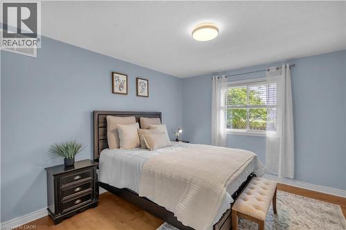 Bedroom featuring light blue painted walls and wood-finish flooring - 65 Thistlemoor Drive, Caledonia, ON - Indoor Photo Showing Bedroom