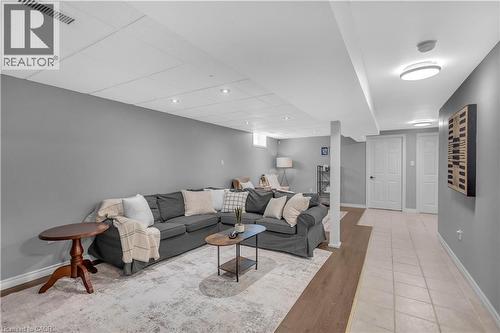 Spacious lower-level area featuring recessed lighting, a drop ceiling, and light gray painted walls - 65 Thistlemoor Drive, Caledonia, ON - Indoor Photo Showing Other Room