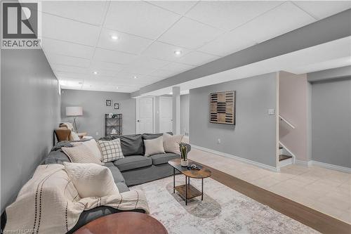 Spacious lower-level area with light gray walls, recessed ceiling lighting, and a drop ceiling - 65 Thistlemoor Drive, Caledonia, ON - Indoor Photo Showing Living Room