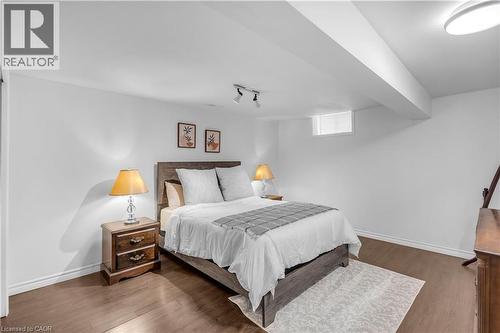Bright bedroom space with wood-finish flooring, crisp white walls, and a recessed window - 65 Thistlemoor Drive, Caledonia, ON - Indoor Photo Showing Bedroom