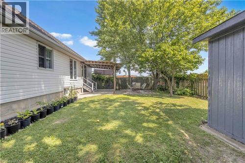 Expansive lawn area featuring mature trees and a privacy fence - 65 Thistlemoor Drive, Caledonia, ON - Outdoor