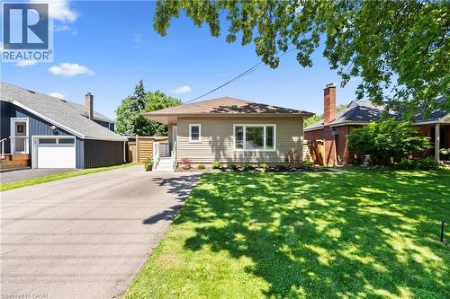 Ranch-style exterior with neutral siding, a front lawn, and a paved driveway - 258 Sanatorium Road, Hamilton, ON - Outdoor