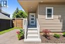 Front entrance featuring light beige siding, a contemporary entry door with frosted glass panels, and a white railing - 258 Sanatorium Road, Hamilton, ON  - Outdoor With Exterior 
