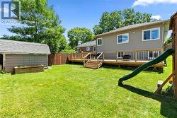 Expansive green lawn with a wood privacy fence - 