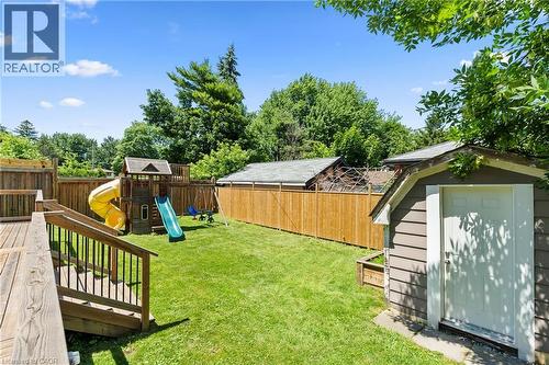 Expansive backyard featuring a wood deck with railings, a well-maintained lawn, a privacy fence, and a storage shed - 258 Sanatorium Road, Hamilton, ON - Outdoor