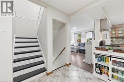 Staircase with contrasting risers and treads, alongside an open floor plan - 