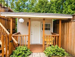 Covered porch entry featuring wood railings and columns - 