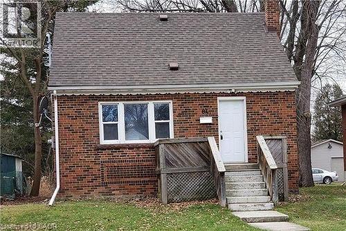 Brick facade home featuring a gabled roof and a prominent front door - 84 Ewen Road, Hamilton, ON - Outdoor