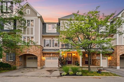 Multi-level townhome featuring a brick and siding facade, private garage, front porch, and second-story balcony - 7 Sirente Drive Unit# 7, Hamilton, ON - Outdoor With Balcony With Facade