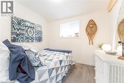 Bright room with light wood-finish flooring and white walls - 