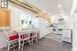 Kitchen area featuring wood-finish flooring and a window - 