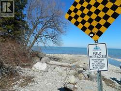 Public water access featuring a rocky shoreline and calm blue waters - 