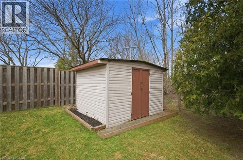 Exterior storage shed with double brown doors, set on a wood-framed base - 200 Morrison Drive, Caledonia, ON - Outdoor