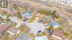 Residential neighborhood featuring a cul-de-sac, paved driveways, established landscaping, and a variety of detached homes - 