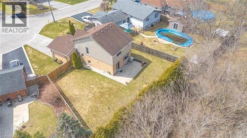 Two-story residence featuring brick and siding exterior, a two-car attached garage, and a large fenced backyard with a concrete patio - 200 Morrison Drive, Caledonia, ON - Outdoor With View