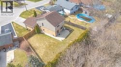 Two-story residence featuring brick and siding exterior, a two-car attached garage, and a large fenced backyard with a concrete patio - 