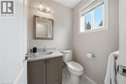 Bathroom featuring a single window, a vanity with a light-toned countertop and cabinet, an oval sink with a chrome faucet, and a wall-mounted light fixture - 200 Morrison Drive, Caledonia, ON - Indoor Photo Showing Bathroom