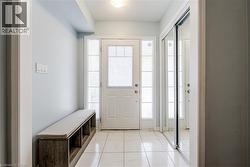 Entryway featuring a white paneled door with frosted glass sidelights and transom - 