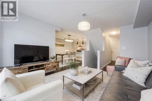 Open-concept living space featuring dark wood-finish flooring - 1000 Asleton Boulevard Unit# 58, Milton, ON - Indoor Photo Showing Living Room