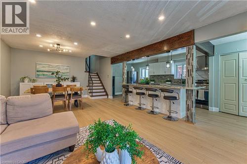 Open-concept living space featuring wood-finish flooring, recessed lighting, and a prominent kitchen island with pendant lighting - 2560 Palisander Avenue, Mississauga, ON - Indoor Photo Showing Living Room