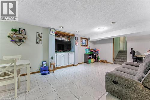 Spacious lower level featuring light tile flooring and recessed lighting - 2560 Palisander Avenue, Mississauga, ON - Indoor Photo Showing Living Room
