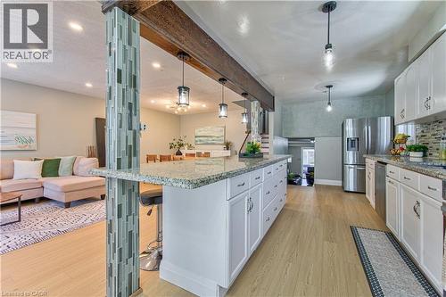 white cabinetry, stainless steel appliances, granite countertops, and a mosaic tile backsplash - 2560 Palisander Avenue, Mississauga, ON - Indoor Photo Showing Kitchen With Upgraded Kitchen