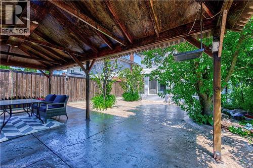 Covered patio featuring a wood-beam ceiling, recessed lighting, and a stamped concrete surface - 2560 Palisander Avenue, Mississauga, ON - Outdoor With Deck Patio Veranda
