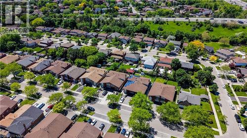 Residential streetscape with established homes, mature trees, and a distant highway - 2560 Palisander Avenue, Mississauga, ON - Outdoor With View