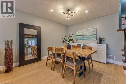 Light wood-finish flooring complements the neutral wall color - 2560 Palisander Avenue, Mississauga, ON - Indoor Photo Showing Dining Room