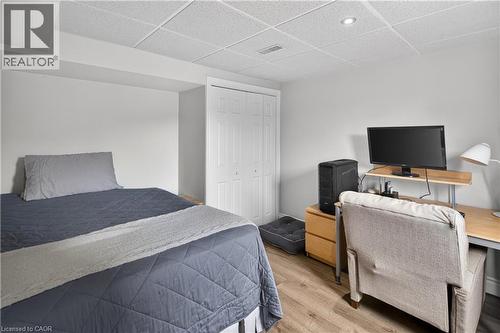 Recessed lighting illuminating the room, featuring wood-finish flooring and a bi-fold door closet - 56 Brookstream Court, Hamilton, ON - Indoor Photo Showing Bedroom