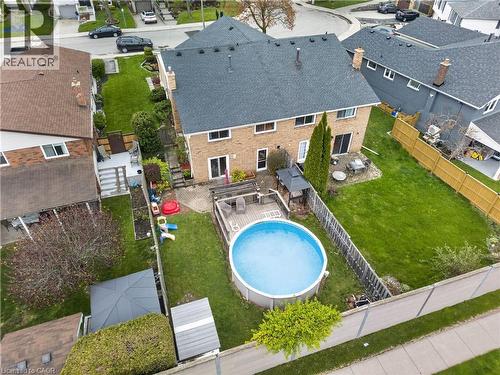 Expansive backyard featuring an above-ground pool, a spacious wooden deck with a gazebo, and a large lawn area - 56 Brookstream Court, Hamilton, ON - Outdoor With Above Ground Pool With Deck Patio Veranda