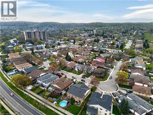 Expansive aerial perspective showcasing a residential neighborhood with varied single-family homes and mature trees - 56 Brookstream Court, Hamilton, ON - Outdoor With View