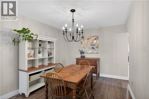 Dining area featuring dark wood-finish flooring, white baseboards, and light-toned walls - 56 Brookstream Court, Hamilton, ON - Indoor Photo Showing Dining Room