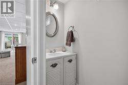 Vanity with integrated sink, chrome faucet, and decorative cabinetry hardware - 