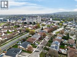 Aerial perspective showcasing a residential area with diverse architectural styles, including multi-story buildings and single-family homes - 