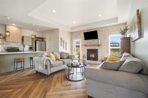 21 Glacier Bay, Steinbach, MB - Indoor Photo Showing Living Room With Fireplace