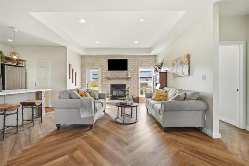21 Glacier Bay, Steinbach, MB - Indoor Photo Showing Living Room With Fireplace