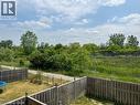Private backyard with wood fencing bordering a natural green space and walking path - 300 Countrystone Crescent, Kitchener, ON  - Outdoor 