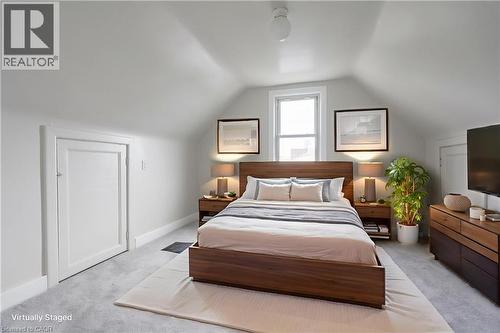 Sloped ceiling bedroom featuring a single window, white trim, and light gray wall paint - 156 Adeline Avenue, Hamilton, ON - Indoor Photo Showing Bedroom