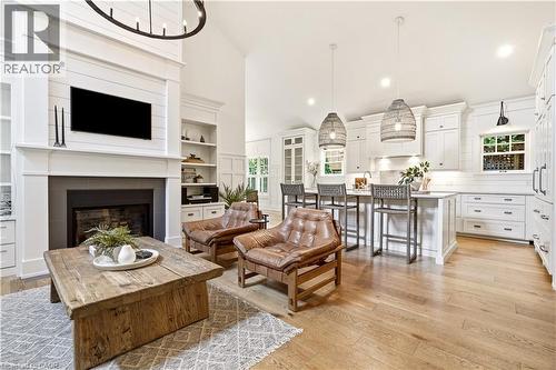 Open-concept living space with vaulted ceiling and wood-finish flooring - 330 Camelot Court, Burlington, ON - Indoor Photo Showing Living Room With Fireplace