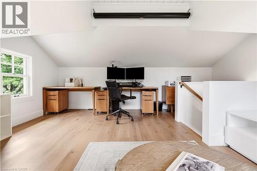 Loft space featuring light wood-finish flooring, a white window frame, and a white stair railing - 330 Camelot Court, Burlington, ON - Indoor Photo Showing Office