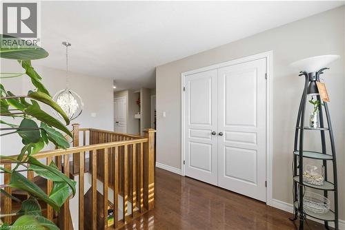 Hardwood flooring throughout the upper level, featuring white trim work and a neutral wall palette - 212 Chartwell Circle, Hamilton, ON - Indoor Photo Showing Other Room