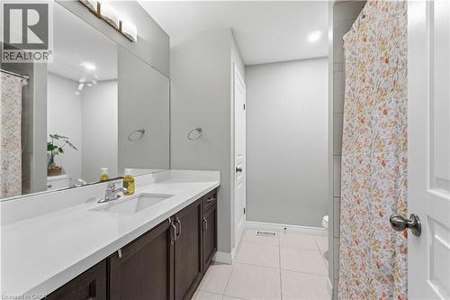 Bathroom featuring a dark wood-finish vanity with a white countertop and an integrated sink - 212 Chartwell Circle, Hamilton, ON - Indoor Photo Showing Bathroom