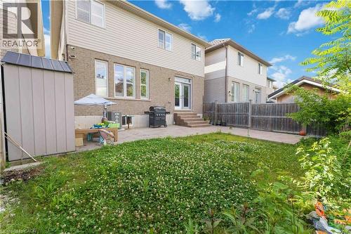 Expansive backyard featuring a patio area, direct access to the interior via double glass doors, a storage shed, and perimeter fencing - 212 Chartwell Circle, Hamilton, ON - Outdoor