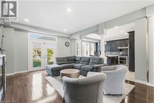 Open-concept living space featuring rich wood-finish flooring and recessed lighting - 212 Chartwell Circle, Hamilton, ON - Indoor Photo Showing Living Room
