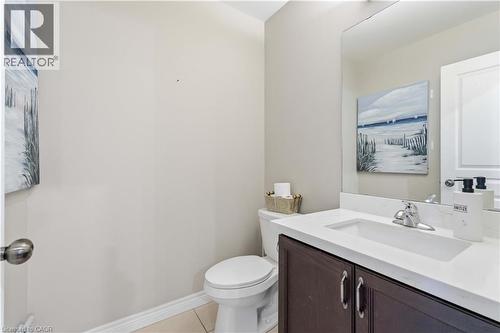 Vanity with a white countertop and integrated sink, chrome faucet, and dark wood-finish cabinetry - 212 Chartwell Circle, Hamilton, ON - Indoor Photo Showing Bathroom