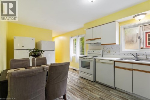 LARGE EAT IN KITCHEN WITH 3 FRIDGES - 25 Saunby Street, London, ON - Indoor Photo Showing Kitchen With Double Sink
