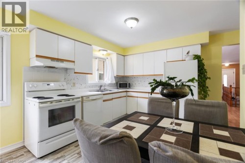 LARGE EAT IN KITCHEN WITH 3 FRIDGES - 25 Saunby Street, London, ON - Indoor Photo Showing Kitchen With Double Sink